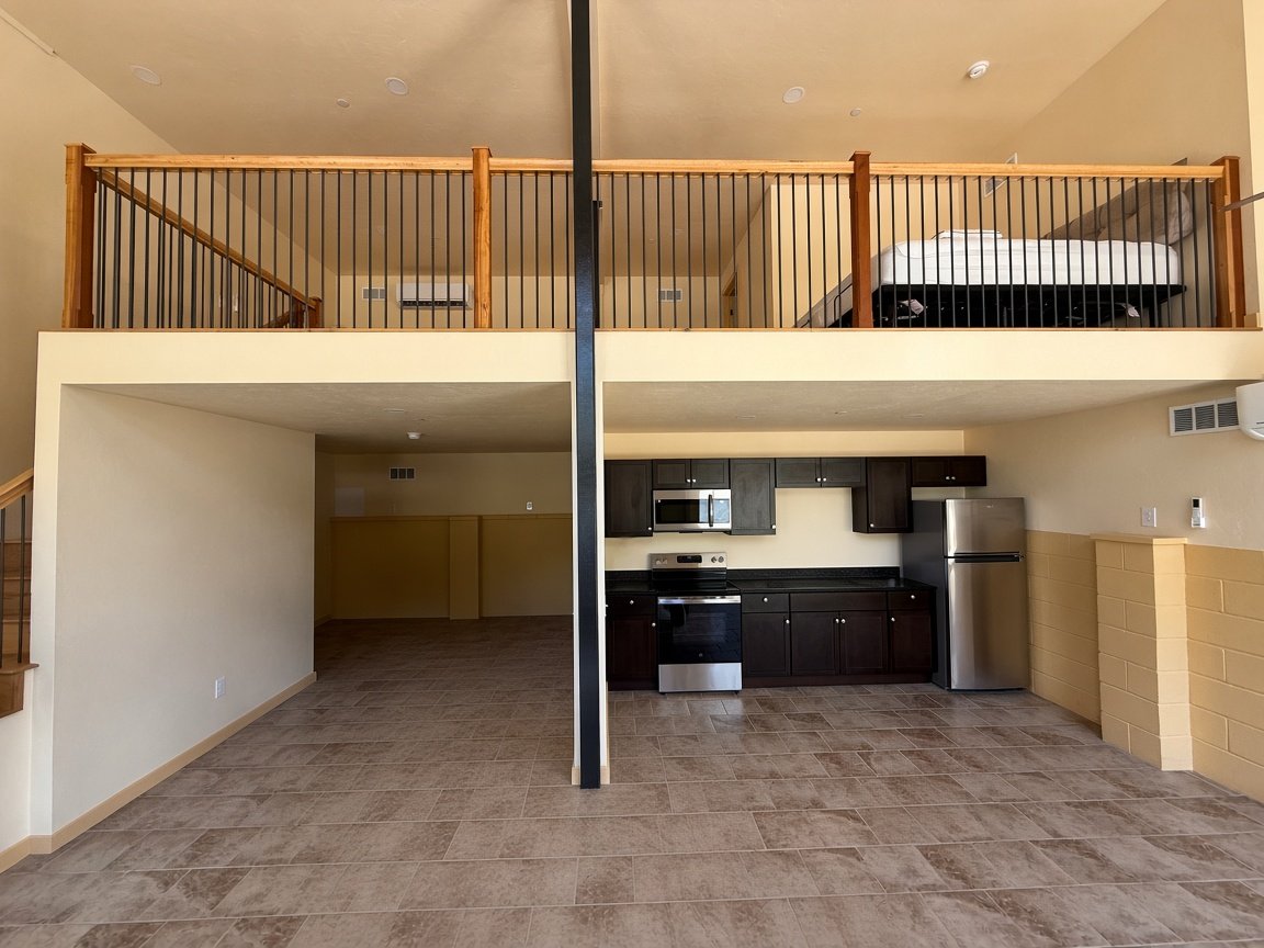 The Throne large loft — open living space with the kitchen below and the sleeping loft above